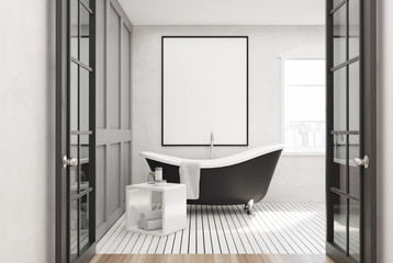 White bathroom, black tub, poster