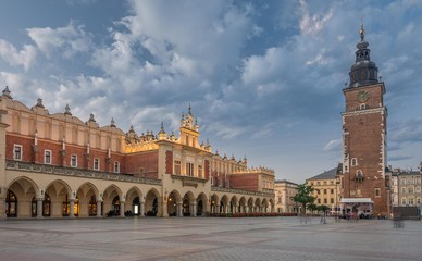 Fototapeta premium Cloth Hall and Town Hall tower on the Main Market Square in Krakow, illuminated in the morning