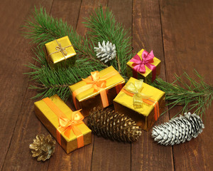 Christmas decorations with gift boxes, candles, tree and balls on wooden background