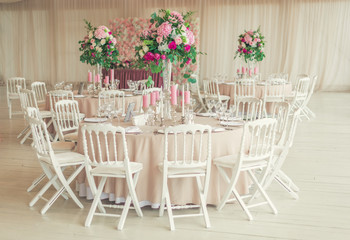a reflective table at a wedding banquet, a table with candles, flowers and a beautiful tableware