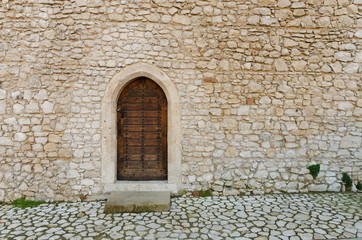 Old ghotic wall with old wooden door