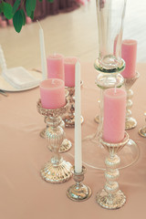 pink candles on a table in a restaurant in a romantic place