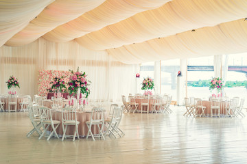a reflective table at a wedding banquet, a table with candles, flowers and a beautiful tableware