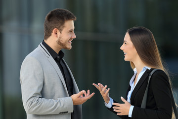 Couple of executives talking on the street