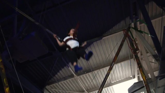 Little boy jumping on a trampoline