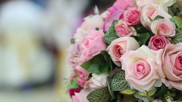 Artificial flower bouquet decor in wedding ceremony with blur light people background.