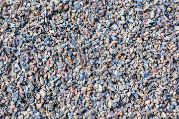 A close-up image of a multicolored fine gravel scattered on the surface.