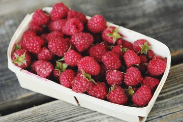 Delicious fresh raspberry in the wooden basket