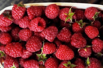 Delicious fresh raspberry in the wooden basket