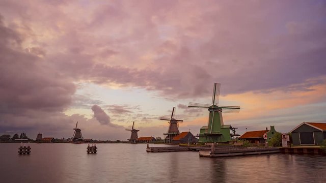 Down motion timelapse of typical Dutch windmills at sunset, Zaanse Schans, Netherlands