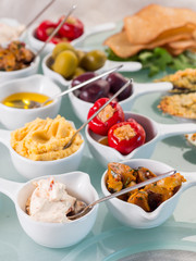 Snack set. Oktoberfest food frame concept. Variety of humus, olives, vegetables, cheese and sauces on white background. Top view
