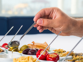 Snack set. Oktoberfest food frame concept. Variety of humus, olives, vegetables, cheese and sauces on white background. Top view