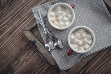 Two metal mugs cocoa with marshmallows