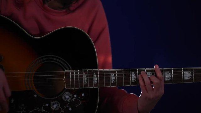 Girl playing acoustic guitar close-up of hands and a beautiful guitar
