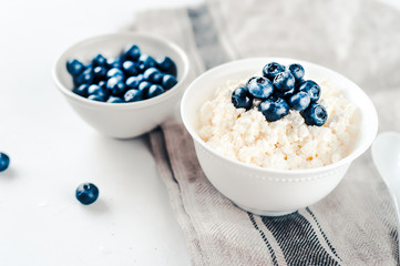Cottage cheese with blueberries in a bowl on a table
