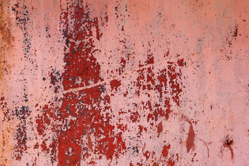 Old metal red painted background with streaks of rust for creativity, textures and backgrounds.