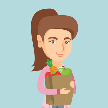Young caucasian woman holding a paper shopping bag with healthy vegetables and fruits. Smiling woman with healthy food. Concept of healthy nutrition. Vector cartoon illustration. Square layout.
