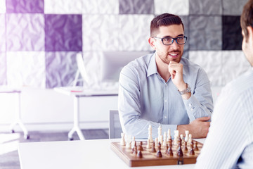 Portrait of two young man playing chess 
