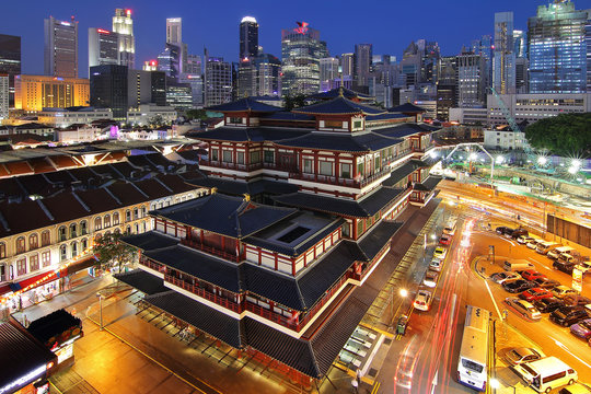 Chinatown, Singapore - July 29, 2017: Buddha Toothe Relic Temple in Chinatown in Singapore, with Singapore`s business district in the background is a beautiful location and very popular for tourists.