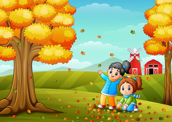 Fototapeta premium Happy kids playing with autumn leaves
