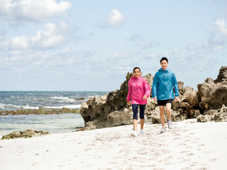 Young Couple Running along sea shore
