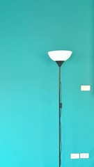 Black lamp on the left with a green background.