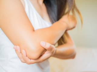 Obraz na płótnie Canvas Closeup female's elbow. Arm pain and injury. Health care and medical concept.