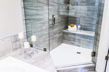 Closeup of staging modern stone grey tiled bathroom, marble countertop in model home, apartment or...