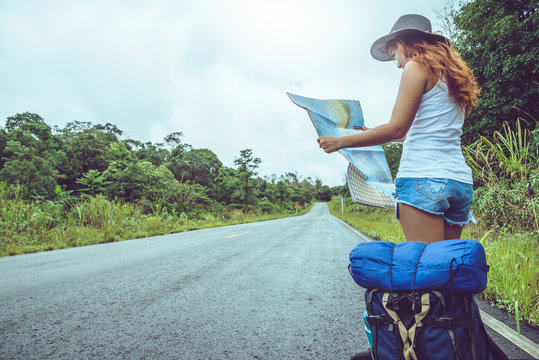 Asian Women Travel Relax In The Holiday. Take A Look At The Map On A Rural Road In The Middle Of Nature. Thailand