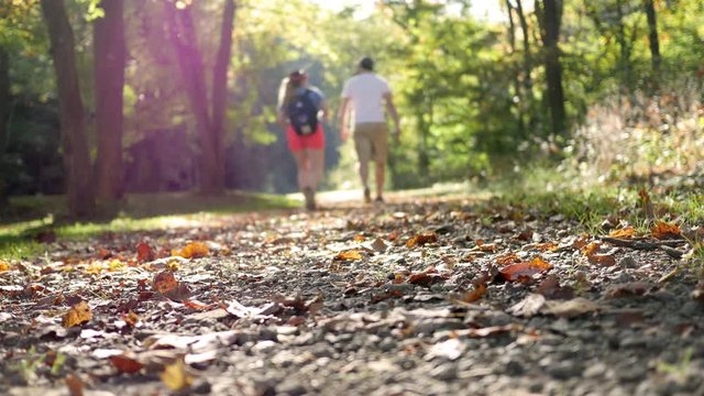 Couple walking through a nature trail on a warm fall afternoon