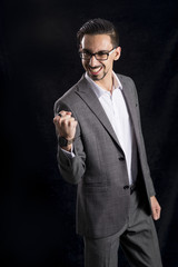 Man in Business Suit Clenches Fist in Delight