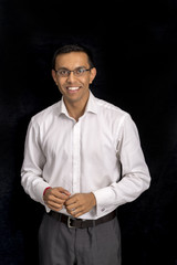 Man in White Sleeved Shirt and Gray Trousers Over Black Background