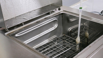 Close up on water bath temperature control.