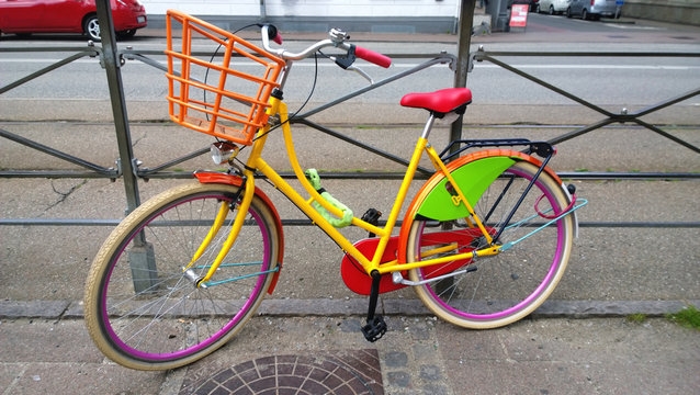 Brightly colored bike parked on the street