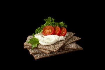 Healthy snack from wholegrain rye crispbread cracker with Cherry tomatoes, salad and soft cheese on...