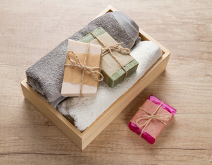 Handmade soap and towels in wooden box