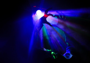 Fototapeta na wymiar silhouette of the heart in disco rays in the smoke