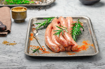 Raw sausages for grilling with spices close up