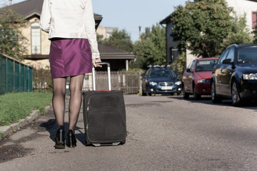 Fototapeta na wymiar woman with travel bag on the street, getting ready for jorney.