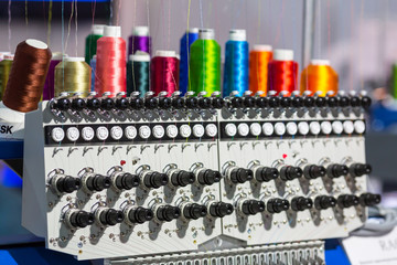 Spools of color threads closeup, spinning machine