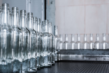 A lot of empty glass bottles on the conveyor