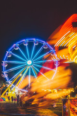 Light streaks with Ferris wheel at carnival