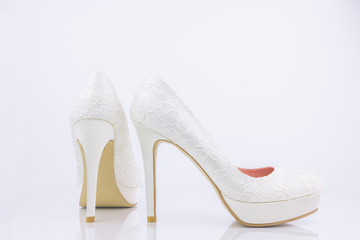 Obraz premium Two Bridal High Heel Shoes On White Background With Reflection