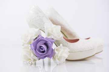 Two Bridal High Heel Shoes On White Background With Reflection With Small Bridal Flower Bouquet 