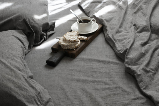 Breakfast in grey bed at sunlight