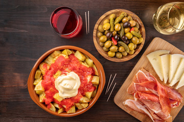 Tapas and wine. Patatas bravas, olives, jamon, cheese