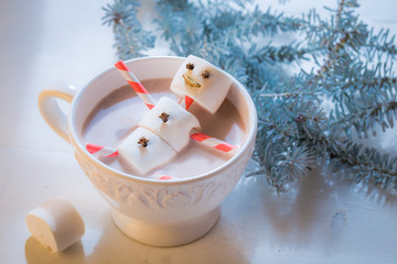 Closeup of funny snowman for Christmas in hot chocolate