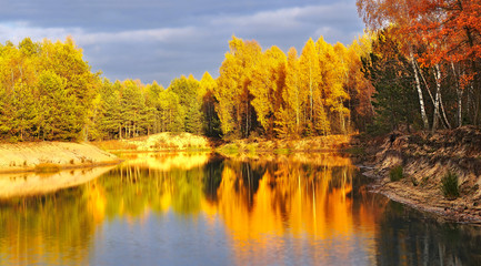 bright, rich colors of autumn foliage reflected in the lake