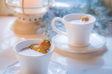 Homemade two gingerbread man in hot chocolate for Christmas