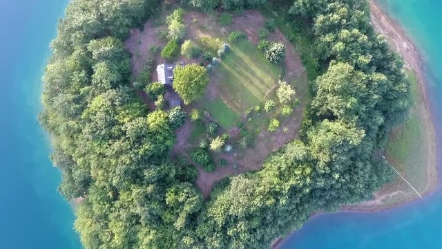 Drone aerial shoot of small island on Ramsko Jezero lake - a tourist destination near Prozor, Bosnia and Herzegovina